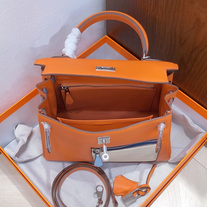 Vibrant Sun Orange Multi-Tone Color Block Compact Trapezoid Hand Tote With Sleek Silvery Twist Lock Hardware And Exterior Zippered Patch Pocket