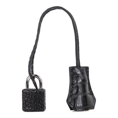 Pale Ash Grey Glossy Black Contrast Compact Trapezoid Hand Tote With Polished Silvery Twist Lock Hardware And Matching Textured Suspended Padlock Charm