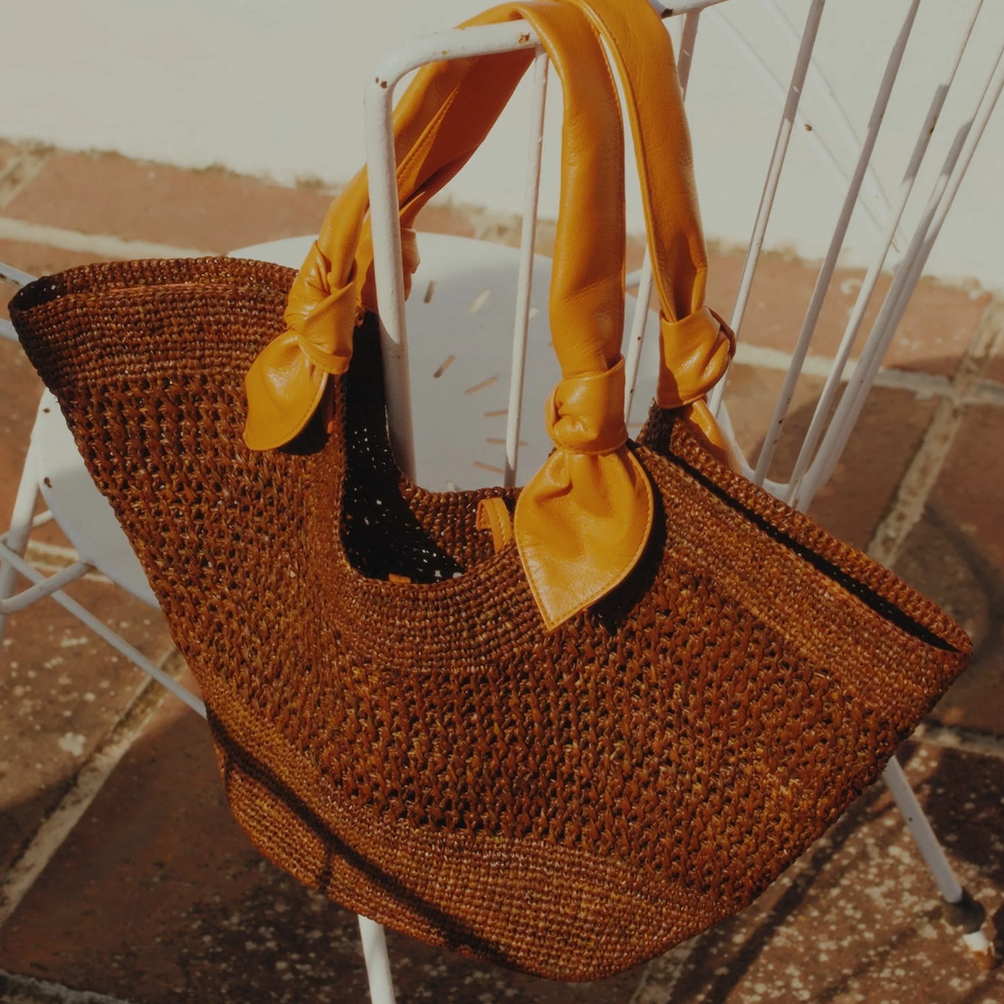 Deep Umber Brown Hand Crocheted Fan Shaped Woven Tote With Vibrant Tangerine Knotted Accent Shoulder Grip Straps